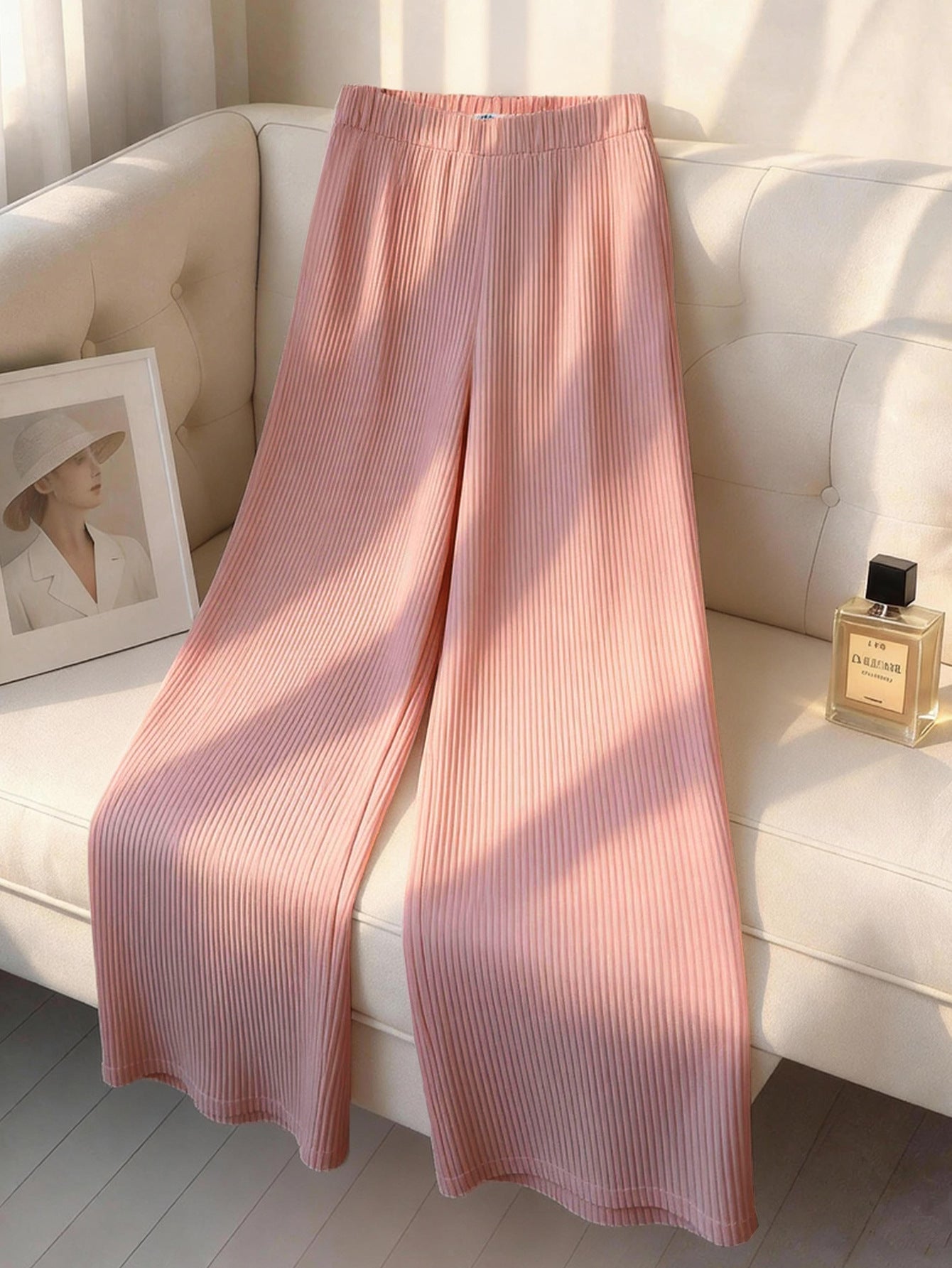 VVZ Ruffled sleeveless loose top paired with high-waisted wide-leg pleated trousers
