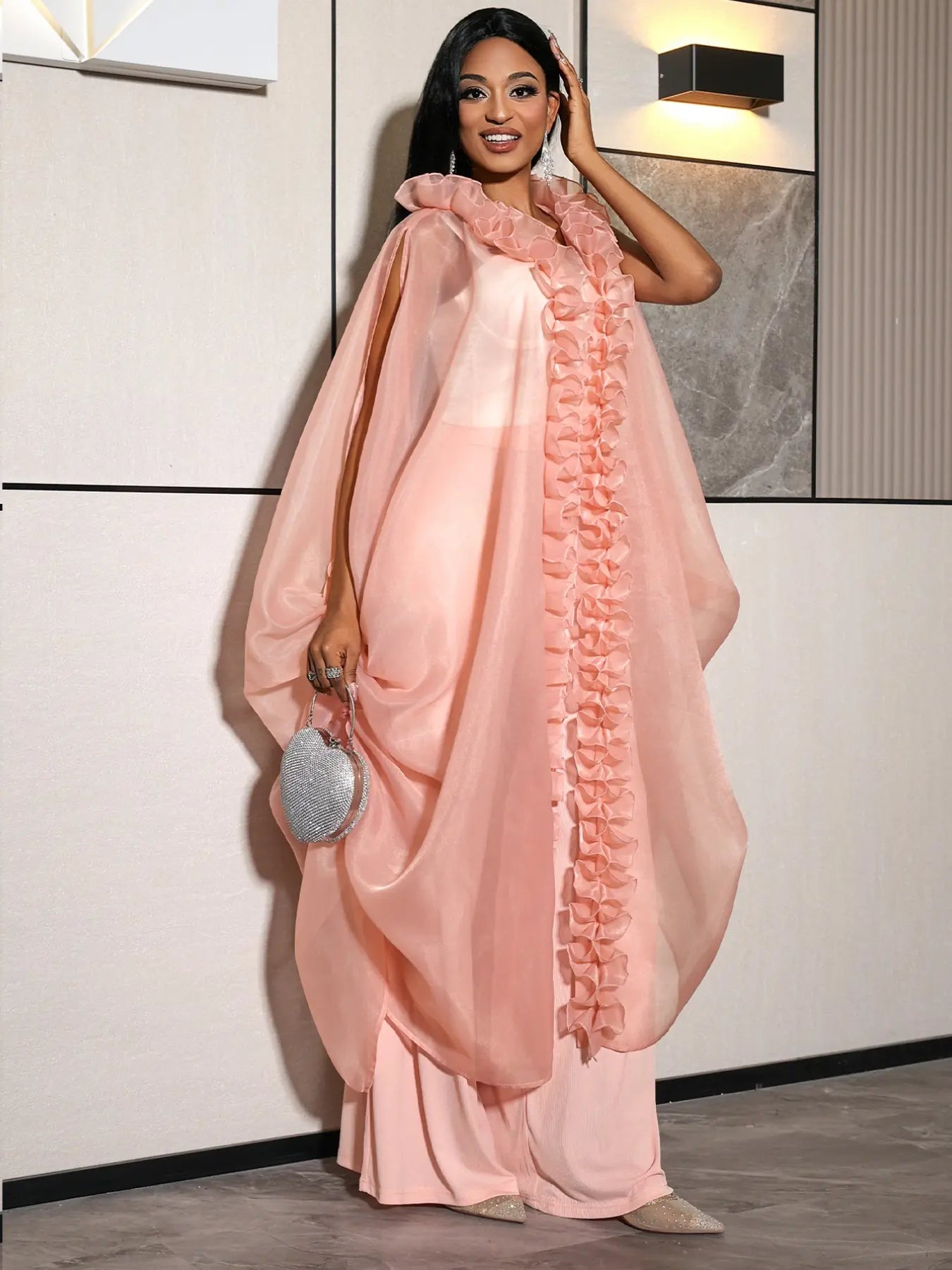 VVZ Ruffled sleeveless loose top paired with high-waisted wide-leg pleated trousers